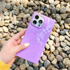A girl holding Neon Lavender - iPhone Square Case in her hand