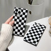 back side of black and white chess board patterned square phone case