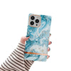 A girl holding Cosmic Chroma - Marble iPhone case - Ocean