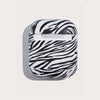 white and black zebra skin patterned, matte apple airpods case showcased from rear side