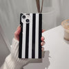 a video showing the beetlejuice themed, black and white iphone square case in different angles